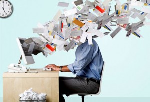 guy at desk with mail flying in his face